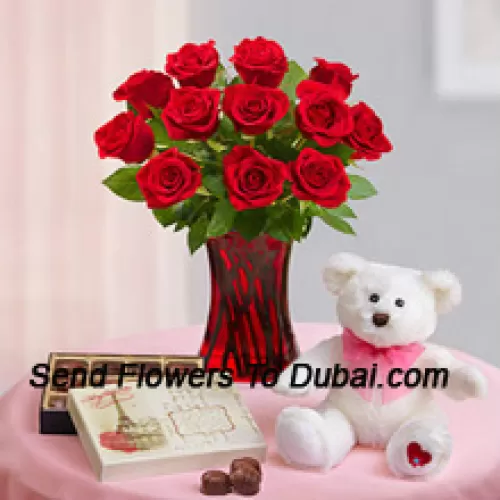 <b>Product Description</b><br><br>12 Red Roses With Some Ferns In A Glass Vase, A Cute 12 Inches Tall White Teddy Bear And An Imported Box Of Chocolates<br><br><b>Delivery Information</b><br><br>* The design and packaging of the product can always vary and is subject to the availability of flowers and other products available at the time of delivery.<br><br>* The "Time selected is treated as a preference/request and is not a fixed time for delivery". We only guarantee delivery on a "Specified Date" and not within a specified "Time Frame".