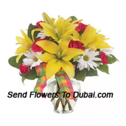 Lys jaunes, Oeillets rouges et des fleurs blanches de saison adaptées, disposés magnifiquement dans un vase en verre