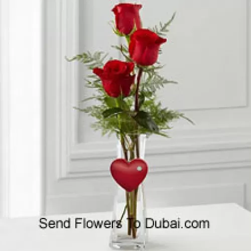 <b>Product Description</b><br><br>3 Red Roses In A Glass Vase Having A Small Heart Attached To It<br><br><b>Delivery Information</b><br><br>* The design and packaging of the product can always vary and is subject to the availability of flowers and other products available at the time of delivery.<br><br>* The "Time selected is treated as a preference/request and is not a fixed time for delivery". We only guarantee delivery on a "Specified Date" and not within a specified "Time Frame".